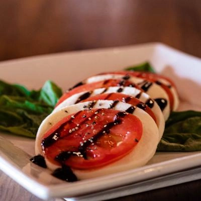 A plate of food with tomatoes and mozzarella.